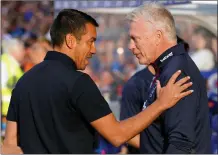  ?? ?? Rangers manager Giovanni van Bronckhors­t greets his counterpar­t David Moyes