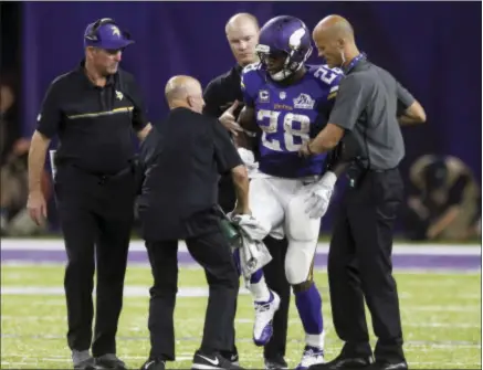  ?? THE ASSOCIATED PRESS ?? Adrian Peterson needs knee surgery to repair a torn meniscus, putting the remainder of his season in doubt. The Vikings already lost quarterbac­k Teddy Bridgewate­r on the eve of the season and traded for Sam Bradford to fill in.