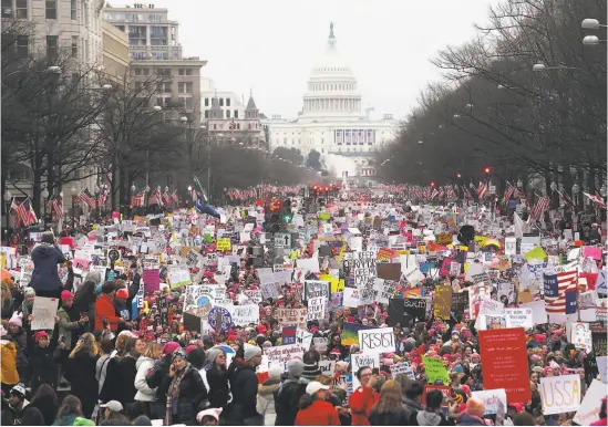  ?? Mario Tama / Getty Images ?? Hundreds of thousands of women — along with some of their male partners and supporters — throng the nation’s capital for a five-hour rally and march.