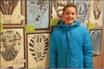  ?? LEAH MCDONALD - ONEIDA DAILY DISPATCH ?? Victoria Leahey, 11, poses in front of her art work at the Oneida City School District’s district-wide art show at Otto Shortell Middle School on Tuesday, March 20, 2018. The show runs until April.