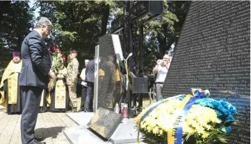 ??  ?? Poroshenko taking part in the opening of a memorial to Ukrainians killed by Polish partisans during the ceremony in Sahryn. – AFP photo