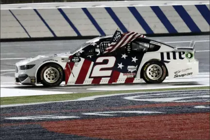  ?? GERRY BROOME — THE ASSOCIATED PRESS ?? Brad Keselowski holds an American flag after winning the NASCAR Cup Series auto race at Charlotte Motor Speedway early Monday, May 25, 2020, in Concord, N.C.