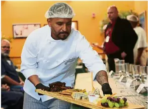  ??  ?? An inmate delivering a charcuteri­e platter during a food service symposium at the prison where inmates learn the ins and outs of the restaurant industry.