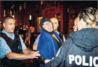  ?? THE CANADIAN PRESS ?? A man is arrested by police after a gunman shot and killed one person and injured another during the Parti Quebecois victory rally in Montreal on Wednesday.