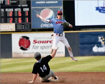  ?? HERALD PHOTO BY JUSTIN SEWARD ?? Prairie Baseball Academy’s Koby Smith is forced to go airborne in order to throw the ball to first base and complete the double play, as Vancouver Island University Mariners’ James Joyce slides into him during Canadian College World Series action at Spitz Stadium on Thursday.