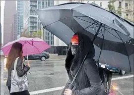  ?? Gabriella Angotti-Jones Los Angeles Times ?? ALEXANDRIA CASSERLY, who teaches fashion and makeup design to children, some of them with autoimmune diseases, wears a mask while walking downtown.