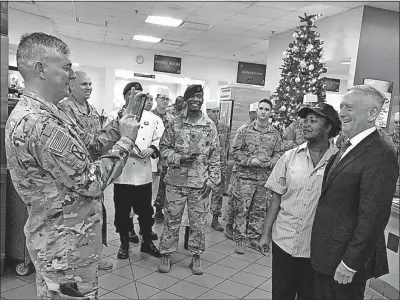  ?? [ROBERT BURNS/THE ASSOCIATED PRESS] ?? Lt. Gen. Stephen Townsend takes a photo Friday of Defense Secretary Jim Mattis and a dining facility worker at Fort Bragg, N.C. Mattis visited Fort Bragg as part of his two-day pre-holiday tour of bases to greet troops.