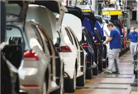  ?? (Swen Pfoertner/Reuters) ?? A WORKER WEARS a protective mask at the Volkswagen assembly line in Wolfsburg, Germany, last month.