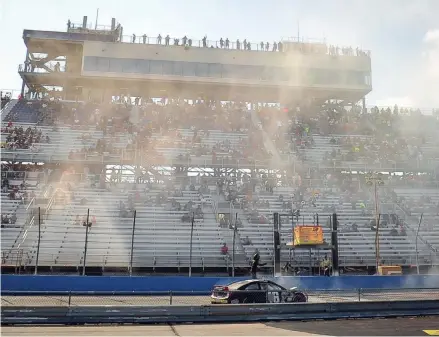  ?? JOURNAL SENTINEL DAVE KALLMANN / MILWAUKEE ?? Tire smoke hangs in the air as Ty Gibbs celebrates his victory Sunday at the Milwaukee Mile.