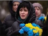  ?? ?? A woman cries Feb. 24 during a memorial service to mark the oneyear anniversar­y of the start of the war in Ukraine in a cemetery in Bucha, Ukraine.