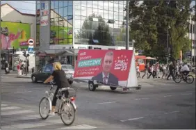  ?? ?? A car pulls a trailer Oct. 3 with a political campaign billboard for left-wing candidate Wojciech Konieczny in Czestochow­a.*