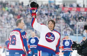 ?? — THE CANADIAN PRESS ?? Former Jets star Teemu Selanne waves to the crowd at Investors Group Field before the first period of the NHL Heritage Classic alumni game in Winnipeg on Saturday.