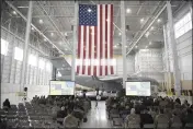  ?? PHOTOS BY JOEL ROSENBAUM — THE REPORTER ?? Beneath a large United States flag hung from the ceiling of Hangar 837 at Travis Air Force Base, United States Air Force Colonel Derek M. Salmi the Commander of the 60th Air Mobility Wing at Travis Air Force Base, delivers his State of the Base address Thursday in Fairfield.