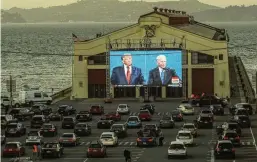  ?? THE NEW YORK TIMES ?? The final presidenti­al debate between then-president Donald Trump and Joe Biden, his Democratic challenger, is projected during a drive-up watch party in San Francisco on Oct. 22, 2020. Biden said on Friday he would participat­e in a general-election debate with Trump.