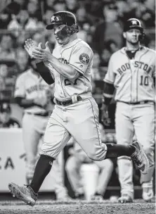  ?? Brett Coomer / Staff photograph­er ?? The Astros’ Jose Altuve crosses the plate to score on a wild pitch in the seventh inning of Game 3 of the ALCS on Tuesday.