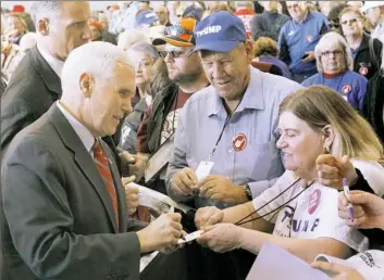  ?? Katie Rausch/Block News Alliance ?? Republican vice presidenti­al candidate Mike Pence, left, greets supporters as he campaigns Tuesday at Grand Aire Inc. in the Toledo Express Airport in Swanton, Ohio.
