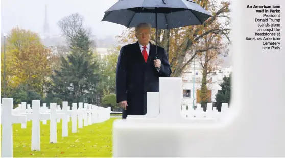  ??  ?? An American lone wolf in Paris: President Donald Trump stands alone amongst the headstones at Suresnes American Cemetery near Paris