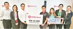  ??  ?? OCBC Kota Kinabalu Branch senior manager Kevin Lim (third from left) hands over the donation to 2018 JCI Tanjung Aru’s Say No To Shark Fin Soup project chairperso­n Wilson Gan (fourth from right).