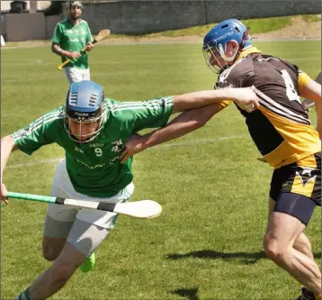  ??  ?? Robbie Barron of St. James’ tries to find a way past Aidan Murphy (Ballygarre­tt) in Sunday’s The Courtyard IHC Group A encounter in Bellefield.