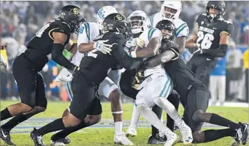  ?? Wally Skalij Los Angeles Times ?? UCLA’S SOSO JAMABO picks up a crucial first down in the fourth quarter against Colorado at Rose Bowl.