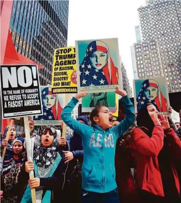  ?? AFP ?? Muslim women protest against US President Donald Trump in Chicago, Illinois., on Sunday.