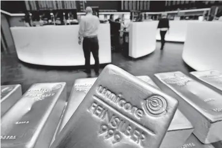  ??  ?? Silver bars are displayed May 9, 2007, in the trading room of the stock exchange in Frankfurt, Germany. Silver futures jumped more than 10% on Monday following strong gains over the weekend. [MICHAEL PROBST/ASSOCIATED PRESS FILE PHOTO]