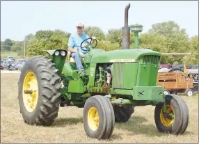  ?? Westside Eagle Observer/RANDY MOLL ?? Frank Leeman drives a John Deere tractor belonging to Russell Leeman in the Parade of Power last year during the Tired Iron of the Ozarks fall show in Gentry.