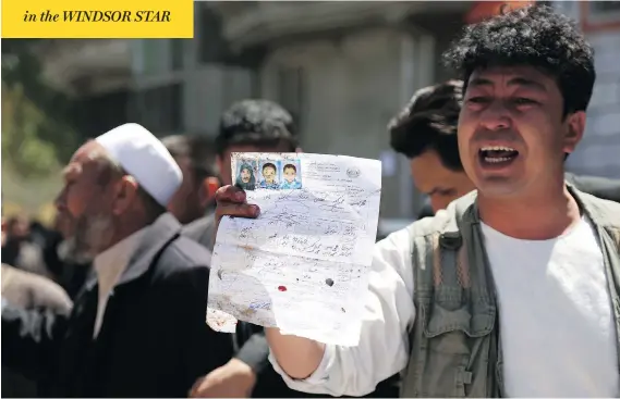  ?? RAHMAT GUL / THE ASSOCIATED PRESS ?? An Afghan man shows the ID paper of a relative outside a voter registrati­on centre in Kabul that was attacked by an Islamic State suicide bomber on Sunday.