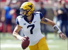  ?? BRAD TOLLEFSON — THE ASSOCIATED PRESS FILE ?? West Virginia’s Will Grier looks to pass against Texas Tech in September in Lubbock, Texas. Grier, a senior, will play in his final home game Friday night when No. 12 West Virginia hosts No. 6 Oklahoma.