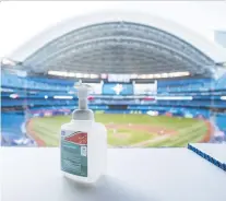  ?? MARK BLINCH/GETTY IMAGES FILES ?? Hand sanitizer is at the ready during a Blue Jays workout at Rogers Centre in Toronto. The Jays’ return-to-play plan includes strict rules for sanitizati­on as well as isolation.