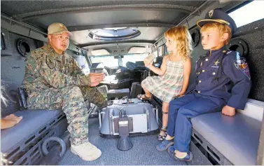  ?? NEW MEXICAN FILE PHOTO ?? Then-Sgt. Ben Valdez visits with children in 2014 inside the Santa Fe Police Department’s BearCat.