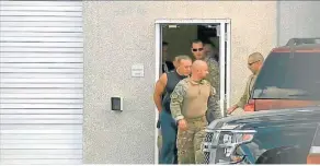  ?? WPLG-TV VIA AP ?? FBI agents escort Cesar Sayoc, in sleeveless shirt, into custody.