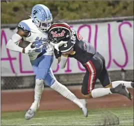  ?? Chris Torres/ The Signal ?? Saugus High wide receiver Aj Goodman (21) scores as he drags Hart defender Izayiah Lopez (3) into the end zone in the second quarter of the game at College of the Canyons on Friday.