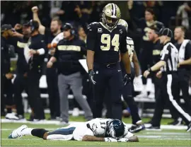  ?? BUTCH DILL — THE ASSOCIATED PRESS ?? Philadelph­ia Eagles wide receiver Alshon Jeffery lies on the turf in front of Saints defensive end Cameron Jordan after New Orleans intercepte­d a pass in a 20-14 win.