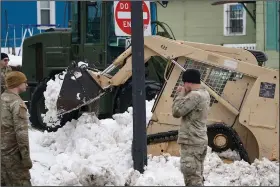  ?? (AP/The Buffalo News/Derek Gee) ?? Soldiers in the National Guard help clear snow Thursday in Buffalo, N.Y.