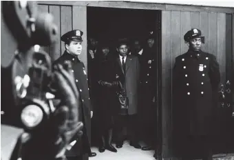  ??  ?? Adger Cowans: Betty Shabazz & Percy Sutton at Malcolm’s Funeral, 1965; from the exhibition ‘Working Together: The Photograph­ers of the Kamoinge Workshop,’ on view at the Whitney Museum of American Art, New York City, through March 28, 2021. For more on Kamoinge, see Emily Raboteau’s conversati­on with Maaza Mengiste and Rachel Eliza Griffiths, to be published in February at nybooks.com.