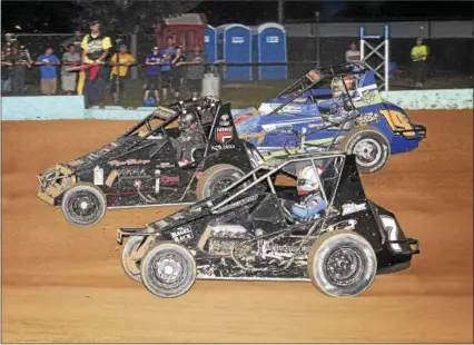  ?? CARL HESS - FOR DIGITAL FIRST MEDIA ?? Here we see Matt Westfall (54), Tim Buckwalter (7) and Steve Drevicki (19s) charging towards the front during the early laps of the USAC SpeedSTR feature. Matt the “Flyin’ Buckeye” Westfall took the win, his first of the year, while Buckwalter captured...