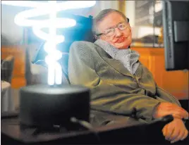  ?? Anthony Devlin ?? Professor Stephen Hawking poses beside a lamp titled “black hole light” by inventor Mark Champkins, presented to him during his 2012 visit to the Science Museum in London. PA