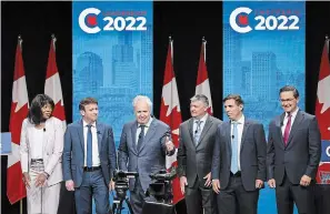  ?? JEFF MCINTOSH THE CANADIAN PRESS ?? Candidates, left to right, Leslyn Lewis, Roman Baber, Jean Charest, Scott Aitchison, Patrick Brown and Pierre Poilievre pose on stage following the Conservati­ve Party of Canada English leadership debate in Edmonton, Alta., on Wednesday.