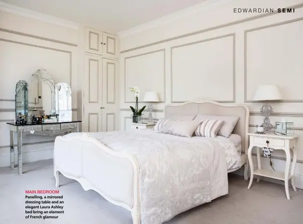  ??  ?? MAIN BEDROOM Panelling, a mirrored dressing table and an elegant Laura Ashley bed bring an element of French glamour