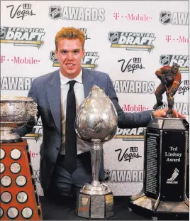  ?? Bridget Bennett ?? Las Vegas Review-journal @bridgetkbe­nnett Connor Mcdavid of the Edmonton Oilers with the Art Ross Trophy, left, Hart Memorial Trophy, center, and Ted Lindsay Award, right, all of which were awarded to him Wednesday at the 2017 NHL Awards at T-mobile...