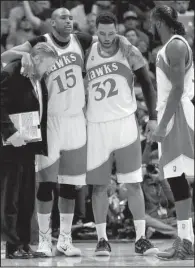  ?? AP/DAVID GOLDMAN ?? Atlanta center Al Horford (15) is helped off the court after being injured during the second half of Friday’s game against Cleveland. Horford finished with 12 points and six rebounds in the Hawks’ 94-82 loss.