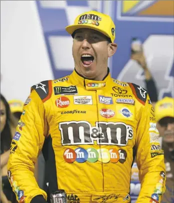  ??  ?? Kyle Busch celebrates winning the NASCAR Cup Series race in Victory Lane Saturday night at Richmond Raceway in Richmond, Va.