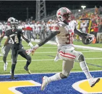  ?? Tom Reel / Staff photograph­er ?? De’Anthony Lewis high-steps into the end zone after a run up the middle in Judson’s 51-48 win over Steele on Friday.