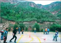  ??  ?? Lyu (third from left) plays soccer with his students at Hekou Primary School in Longxi county, Gansu province.