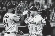  ?? Phil Long / Associated Press ?? Yordan Alvarez (44), who drove in two runs, and George Springer, who scored three, celebrate the Astros’ 70th victory.