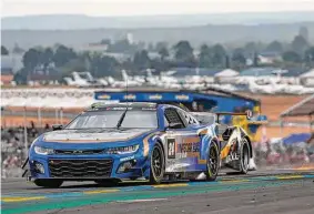  ?? Chris Graythen/Getty Images ?? The No. 24 NASCAR driven by Jimmie Johnson, Jenson Button and Mike Rockenfell­er drives during the 100th anniversar­y of the 24 Hours of Le Mans.