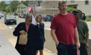  ?? Photograph: Steven Porter/AP ?? Denise Lodge, left, covers her face with a printout of the indictment against her as she walks from the federal courthouse in Concord, New Hampshire, on Wednesday.