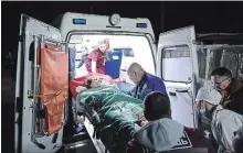  ?? VIKTOR KOROTAEV THE ASSOCIATED PRESS ?? Medics load an injured victim onto an ambulance in Kerch, Crimea, on Wednesday after an 18-yearold student’s shooting rampage.