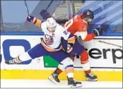  ?? Andre Ringuette Getty Images ?? THE ISLANDERS’ Anders Lee, left, checks the Panthers’ Brett Connolly into the boards in Toronto.